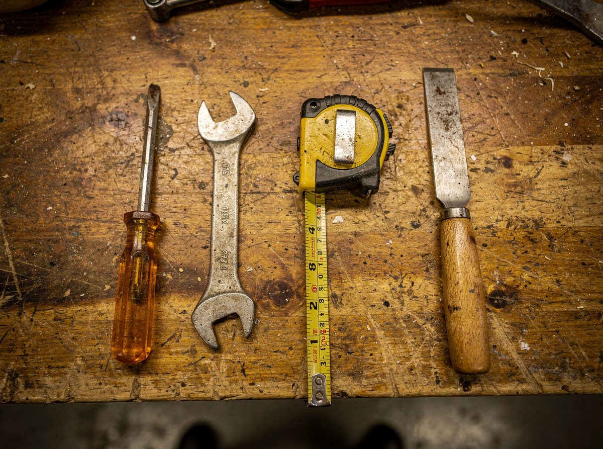 Assorted hand tools laid out on a workbench
